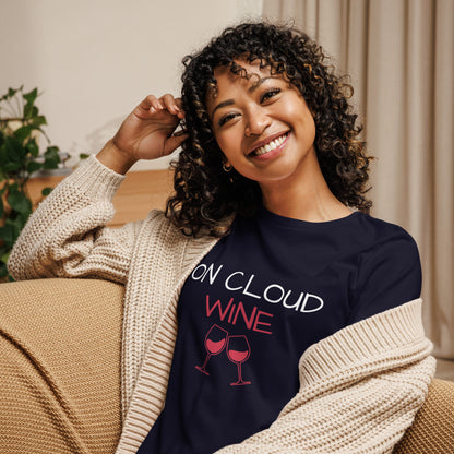 Woman smiling and wearing "On Cloud Wine" ladies T-shirt, enjoying a casual and comfortable moment at home.